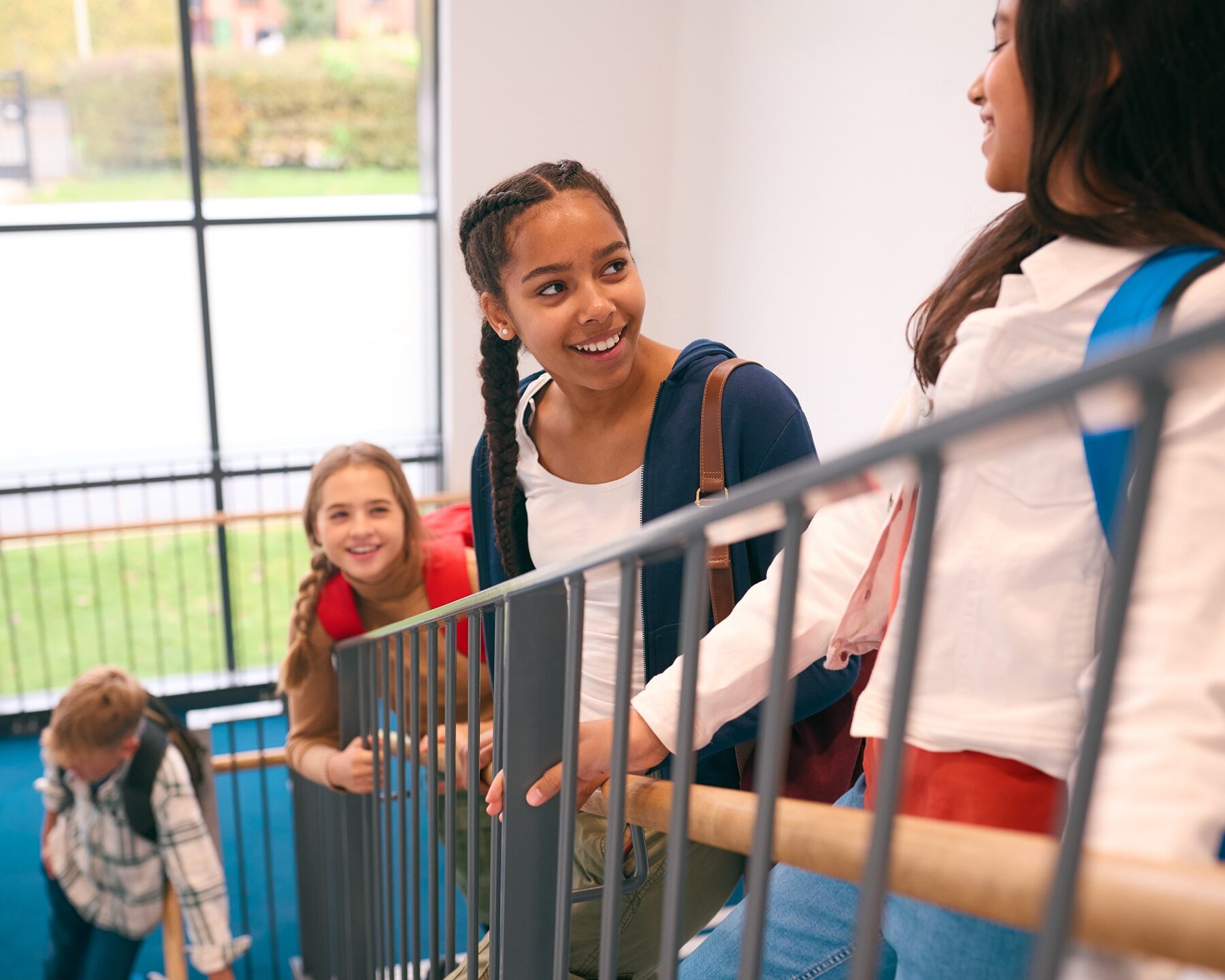 Group Of Secondary Or High School Pupils Inside School Building On Stairs Going To Lesson